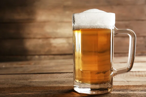 Glass of beer on wooden background — Stock Photo, Image