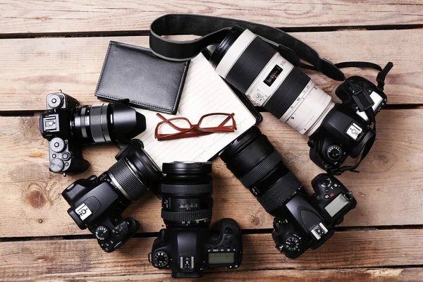 Modern cameras on wooden table — Stock Photo, Image