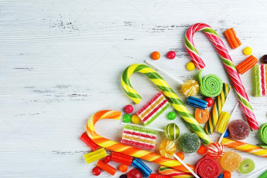 Colorful candies on wooden background