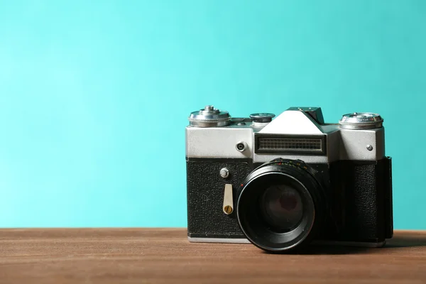 Macchina fotografica retrò sul tavolo su sfondo verde — Foto Stock