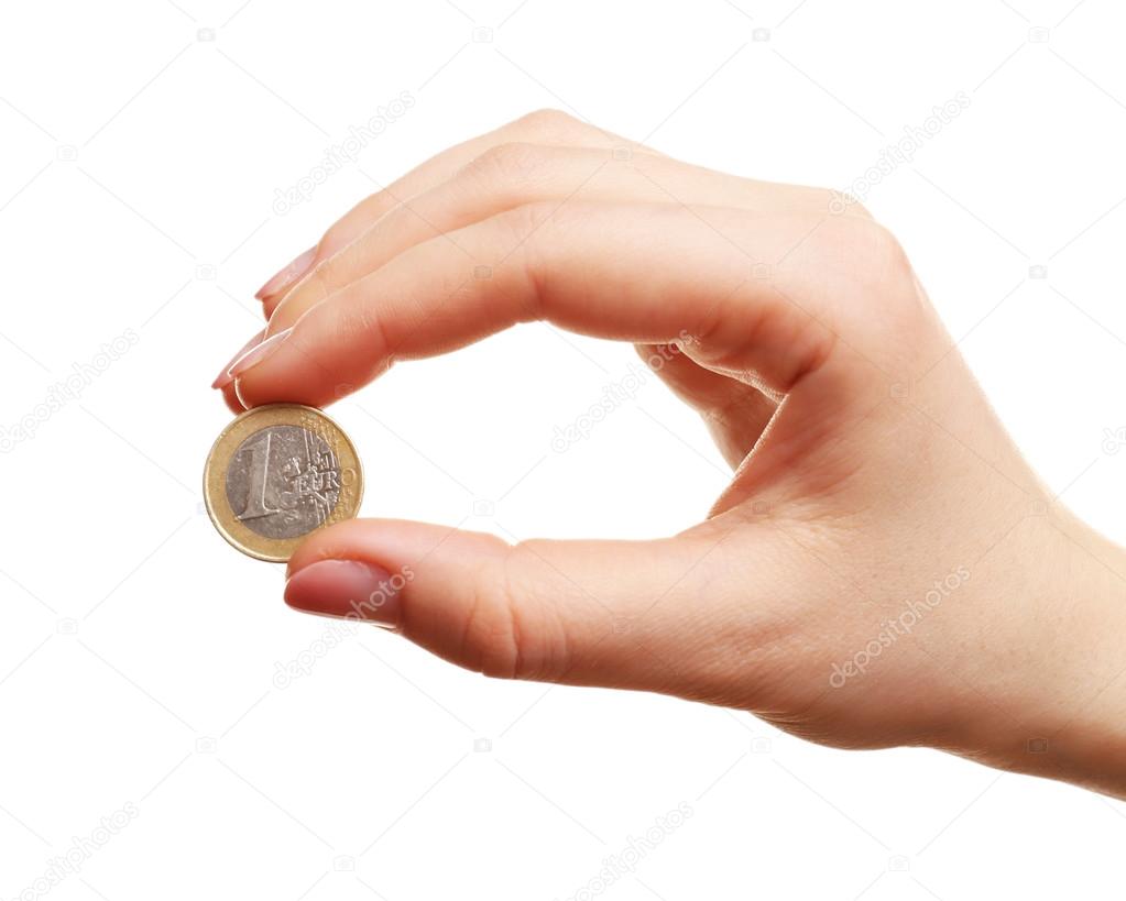 Female hand with coin isolated on white