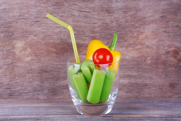 Palitos de apio con pimiento dulce y tomate cherry en vaso con tubo sobre fondo rústico de madera — Foto de Stock