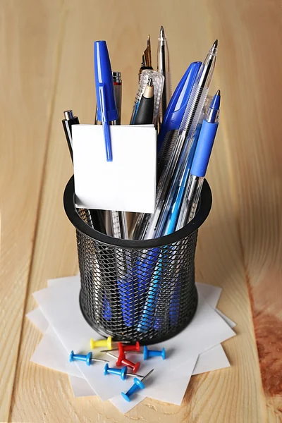 Pens in metal holder on wooden table background — Stock Photo, Image