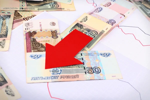 Pengar och röd pil på grafen dokumentet på nära håll — Stockfoto