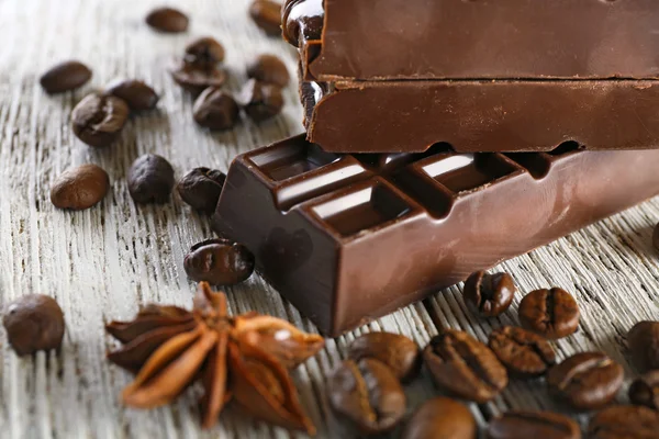 Stuffed chocolate with coffee beans on wooden table, closeup — Stock Photo, Image