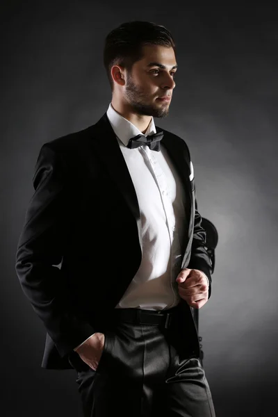 Elegant man in suit on dark background — Stock Photo, Image