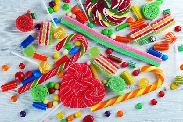 Colorful candies on wooden background — Stock Photo, Image