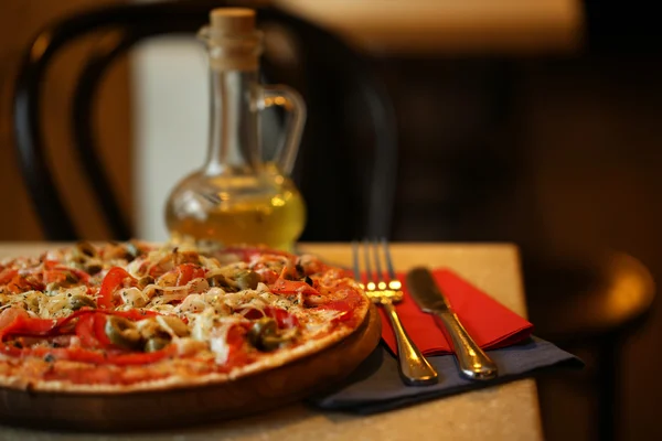 Delicious pizza on table in cafe