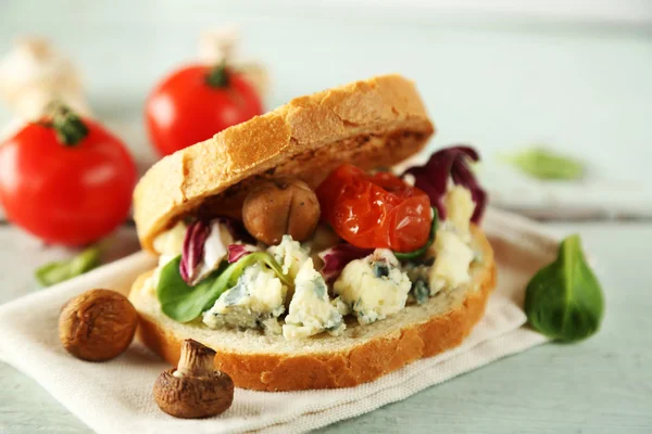 Tasty sandwich on wooden table, close up — Stock Photo, Image