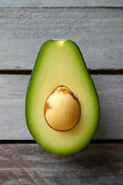 Sliced avocado on wooden background — Stock Photo, Image