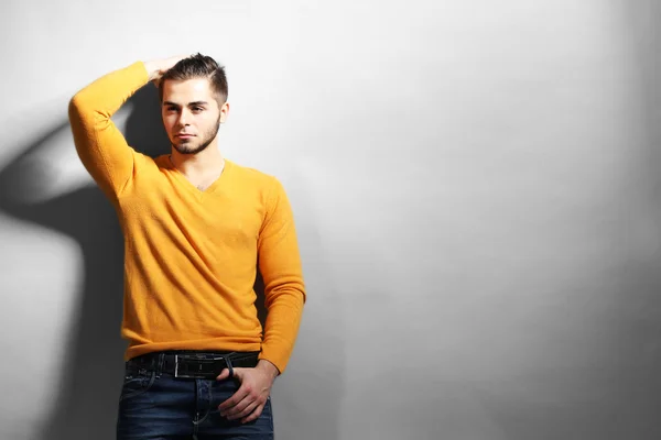 Portrait of young man on gray background — Stock Photo, Image