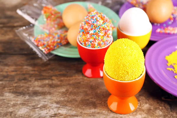 Украшение Пасхальные яйца с красочными бусами на деревянном столе, крупным планом — стоковое фото