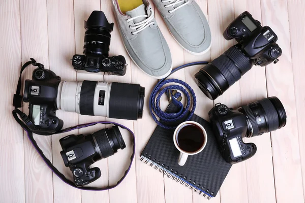 Still life with modern cameras on wooden table, top view — Stock Photo, Image