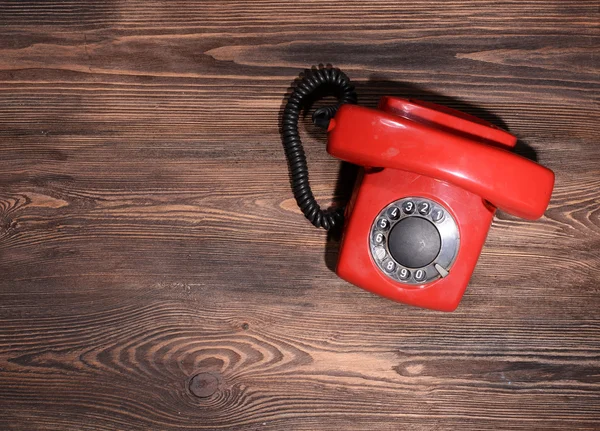 Retro red telephone on table close-up — Stock Photo, Image