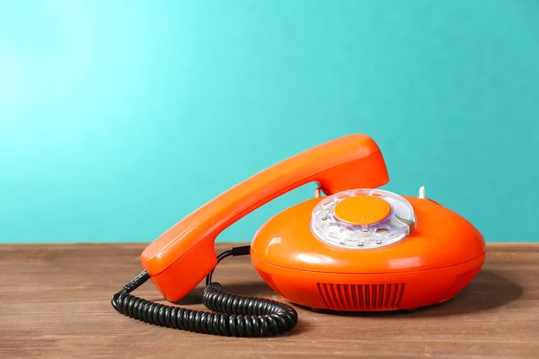 Retro red telephone on table on green background — Stock Photo, Image