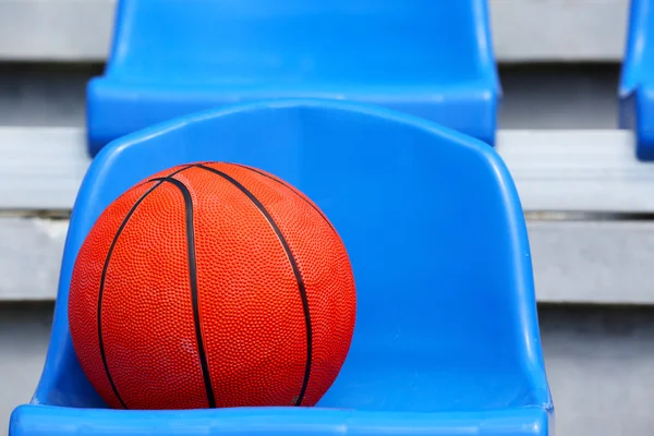 Basketball ball on stadium seat — Stock Photo, Image