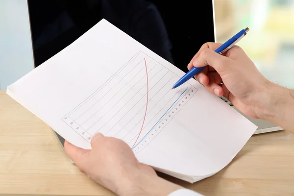 Businessman analyzing charts, closeup — Stock Photo, Image