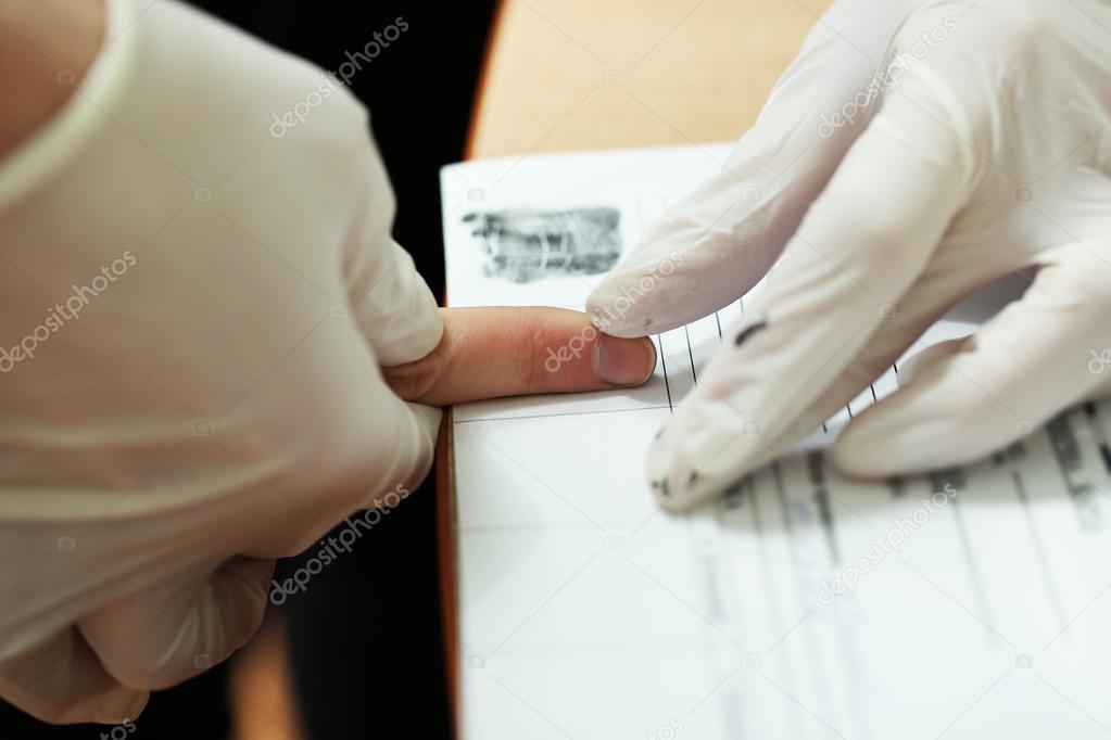 Taking fingerprints in gloves Stock Photo by ©belchonock 72713547