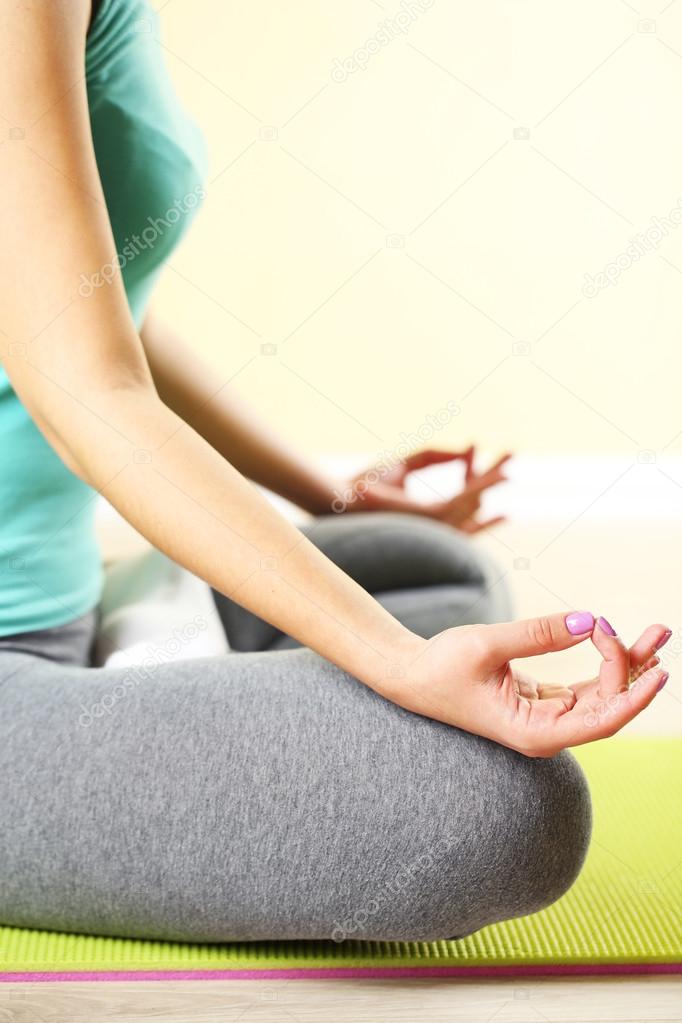 Hand yoga gesture on bright background