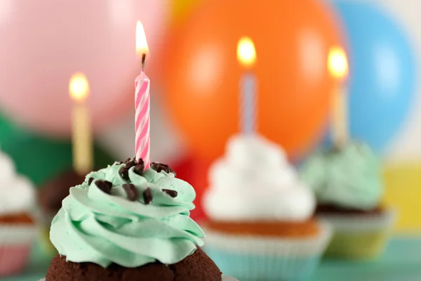 Delicious birthday cupcakes on table on bright background — Stock Photo, Image