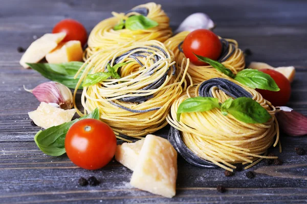 Pastas crudas con queso y verduras sobre fondo de madera —  Fotos de Stock