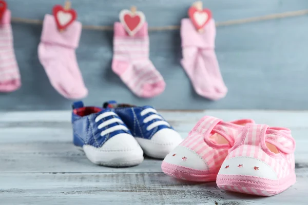 Cute toddler shoes and socks on wooden background — Stock Photo, Image