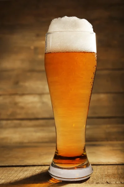 Glass of beer on wooden background — Stock Photo, Image