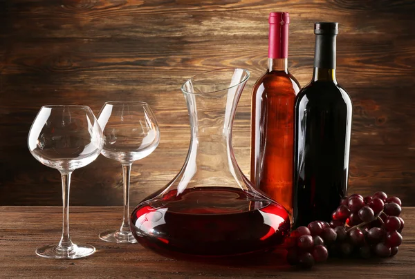 Glass carafe of wine on wooden background — Stock Photo, Image