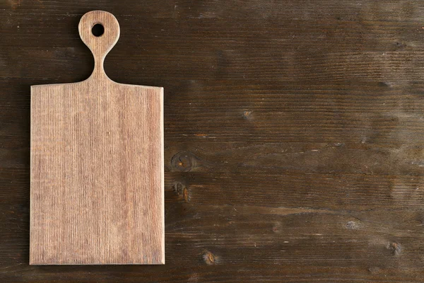 Cutting board on wooden background — Stock Photo, Image