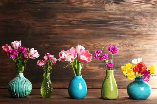 Fresh spring flowers on wooden background — Stock Photo, Image