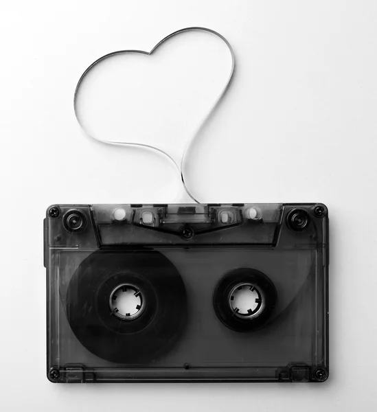 Audio cassette with magnetic tape in shape of heart isolated on white — Stock Photo, Image