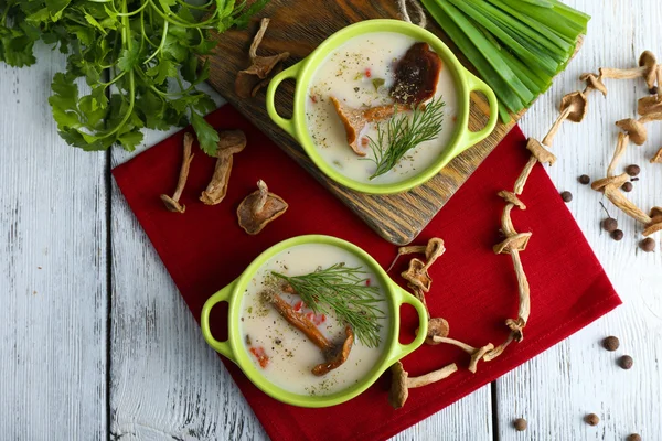 Mushroom soup on wooden table with red napkin, top view — Stock Image Mushroom soup on wooden table with red napkin, top view Royalty Free Stock Photos