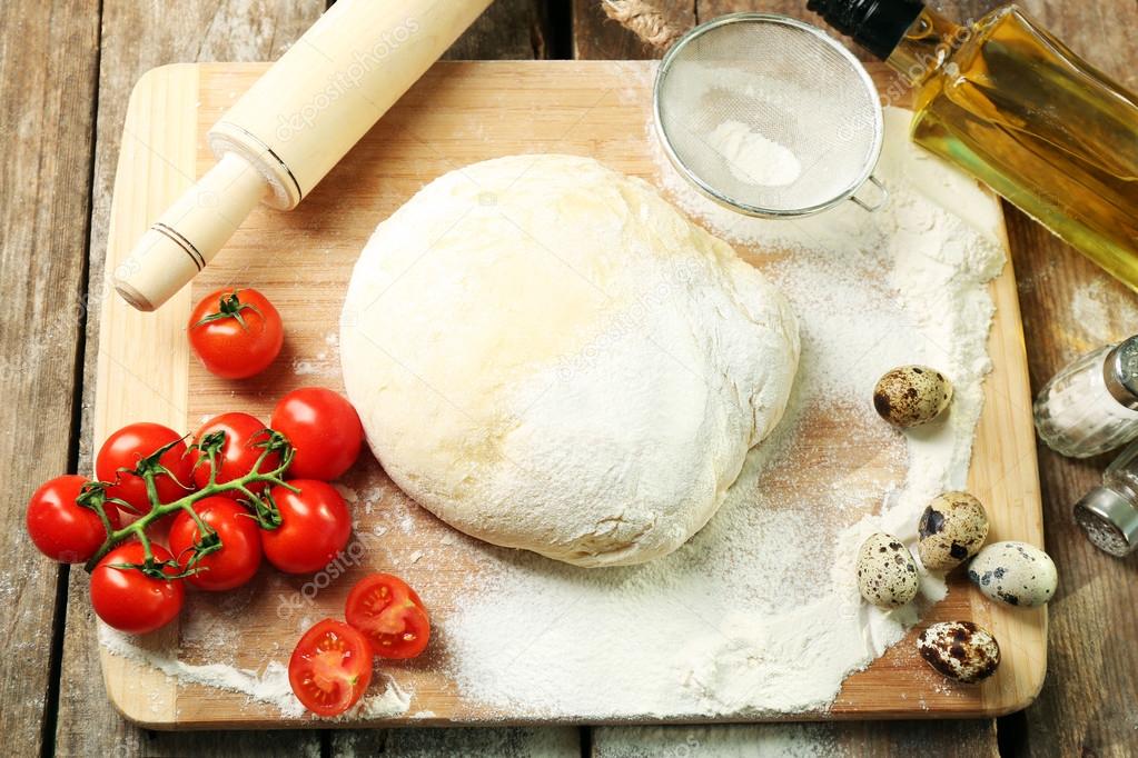 Food ingredients for pizza on table close up