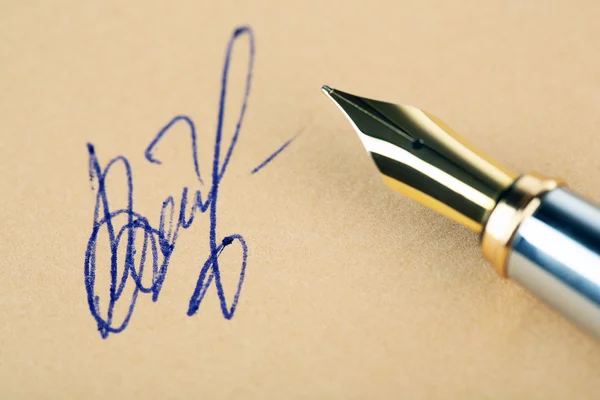 Pen and signature on paper background — Stock Photo, Image