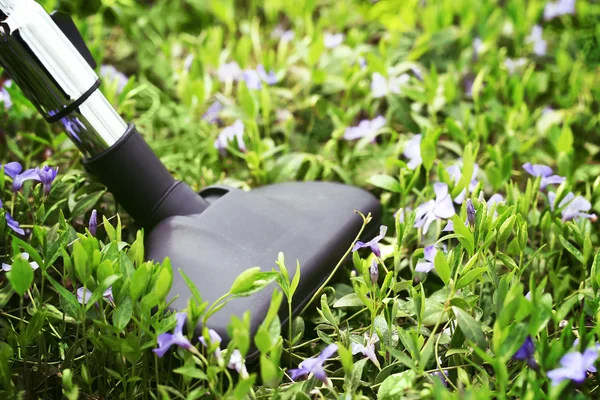 Metal pipe of vacuum cleaner in action - clean carpet of real green grass. Ecology concept — Stock Photo, Image