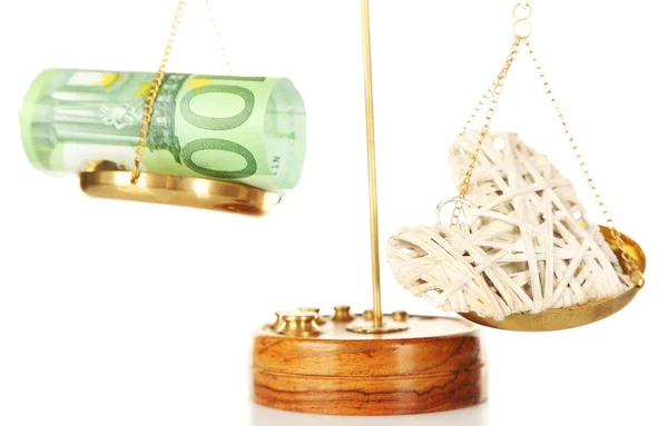 Money and heart in balance scales — Stock Photo, Image