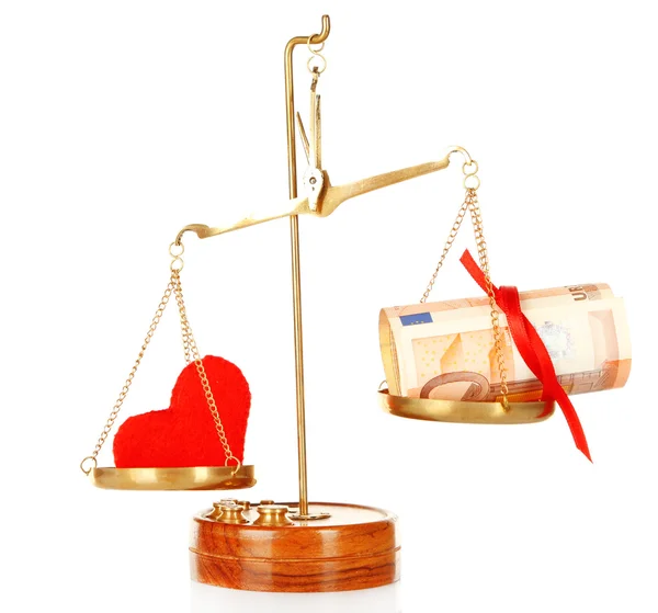 Money and heart in balance scales — Stock Photo, Image