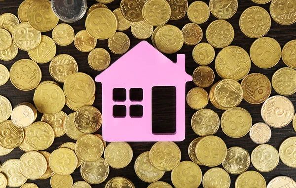 Model of house with pile of coins, closeup — Stock Photo, Image