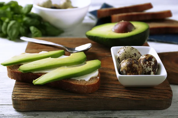 Pan con aguacate en rodajas y huevo de codorniz hervido —  Fotos de Stock