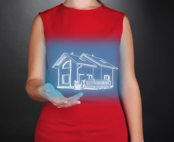 Female hands showing house on dark background — Stock Photo, Image