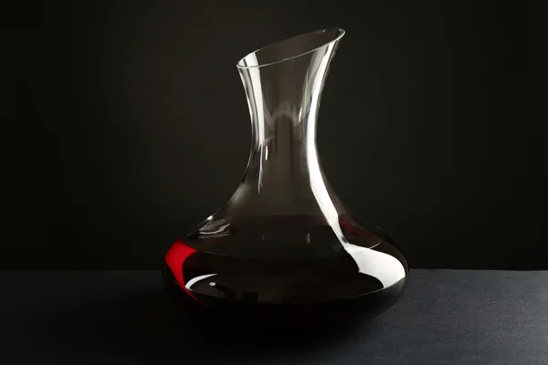 Glass carafe of wine on dark background — Stock Photo, Image