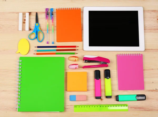 Digital tablet with stationery on wooden background — Stock Photo, Image