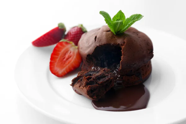 Chocolate fondant with strawberries on white plate, closeup — Stock Photo, Image