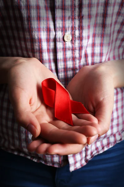 Female hands with color ribbon, closeup — Stock Photo, Image