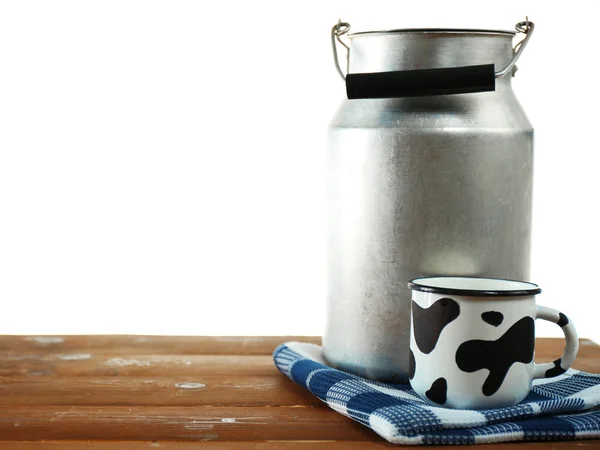 Lattina retrò per latte e tazza di latte su tavolo di legno, su sfondo bianco — Foto Stock