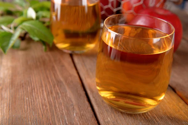 Glasses of apple juice on wooden table, closeup Royalty Free Stock Images