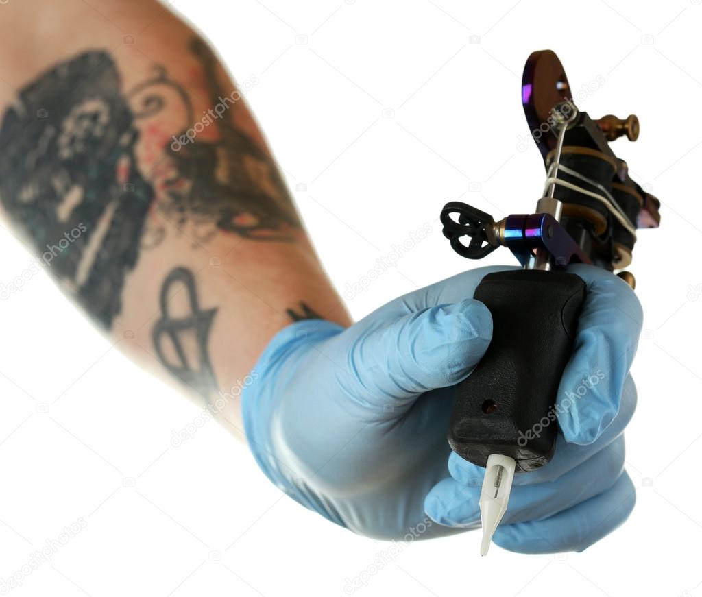 Hand of tattoo artist with tattoo machine isolated on white