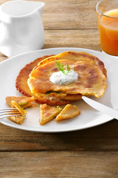 Stack of corn tortillas with stuffing and glass of juice on wooden table background — Stock Photo, Image