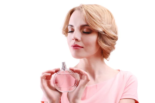 Hermosa joven con botella de perfume aislado en blanco — Foto de Stock