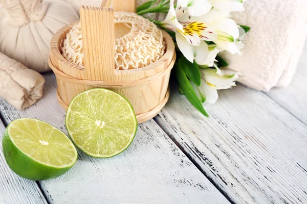 Spa still life with flower and lime on wooden table, closeup — Stock Photo, Image